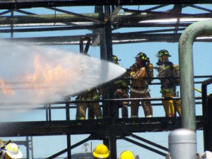 Fire fighters spraying Opens in new window