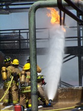 Fire fighters spraying fire